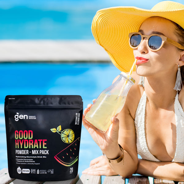 Woman by a pool drinking GoodHydrate, Mix Pack beside her